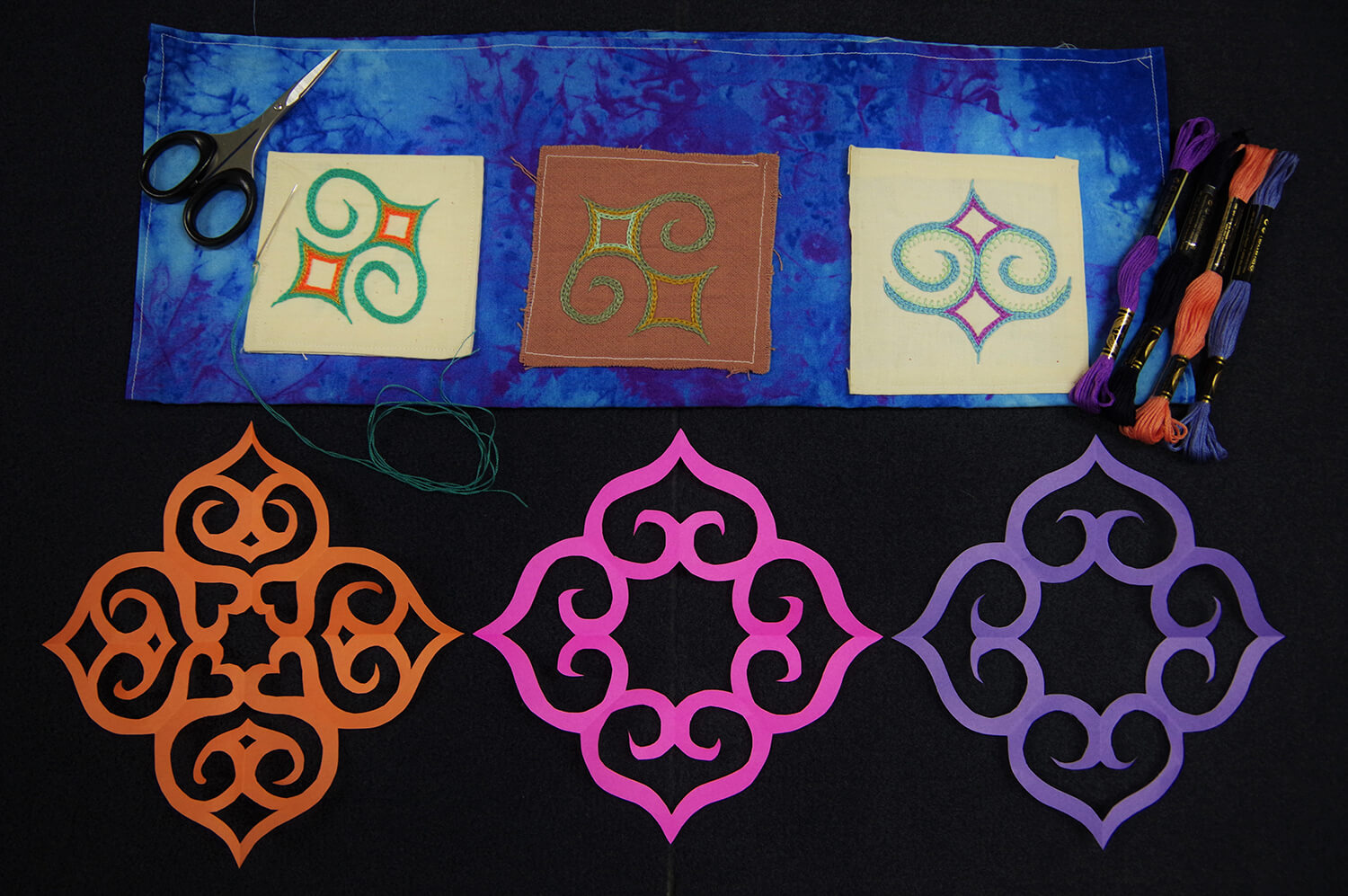 上方是刺繡體驗的範例，下方則是剪紙體驗的範例。 為描繪阿伊努圖案草圖而創作