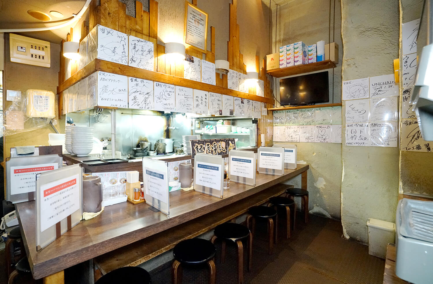 店內擺放著許多名人親筆簽名的彩色紙，上面寫著「很好吃」